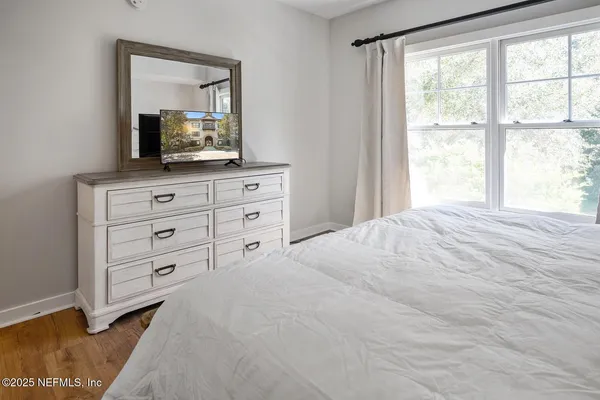 a bedroom with a bed and a television