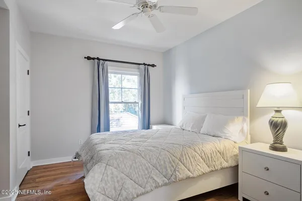 a bedroom with a bed and a window