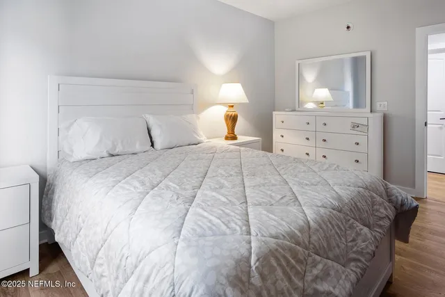 a bedroom with a bed and a night stand