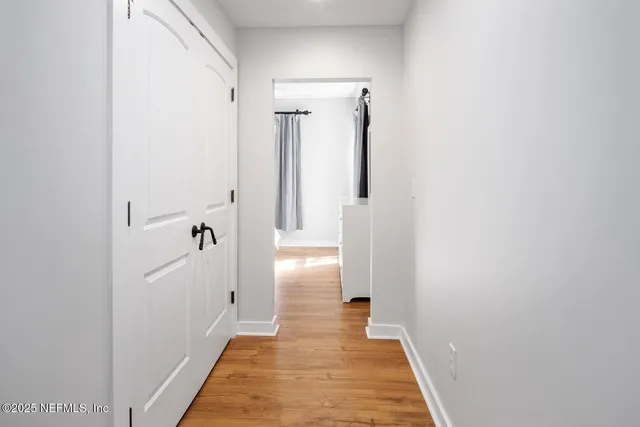 a view of a bathroom from a hallway