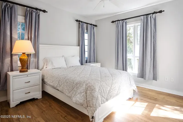 a bedroom with a bed and a night stand