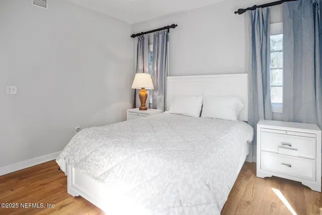 a view of bedroom with wooden floor