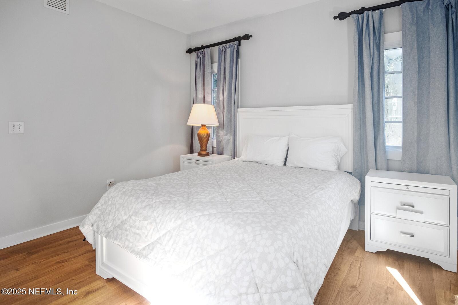 945 Registry Boulevard, Unit 210 St. Augustine, FL 32092 - Photo 24 of 28 a bedroom with a bed and a night stand