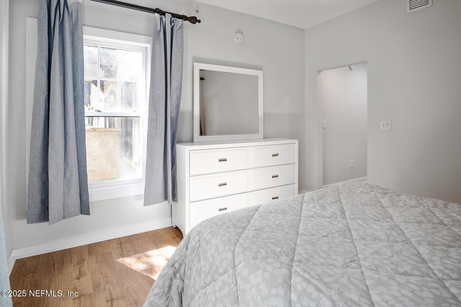 945 Registry Boulevard, Unit 210 St. Augustine, FL 32092 - Photo 25 of 28 a view of bedroom with wooden floor