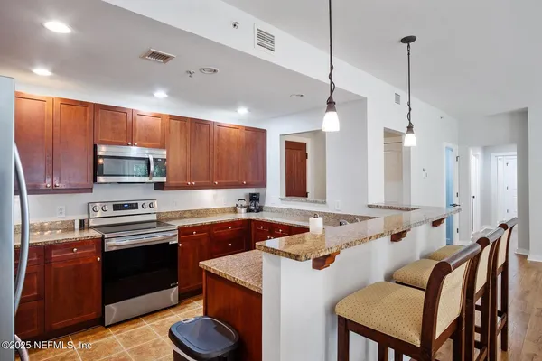 a kitchen with a sink stove and microwave