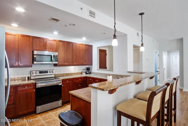 a kitchen with a sink stove and microwave