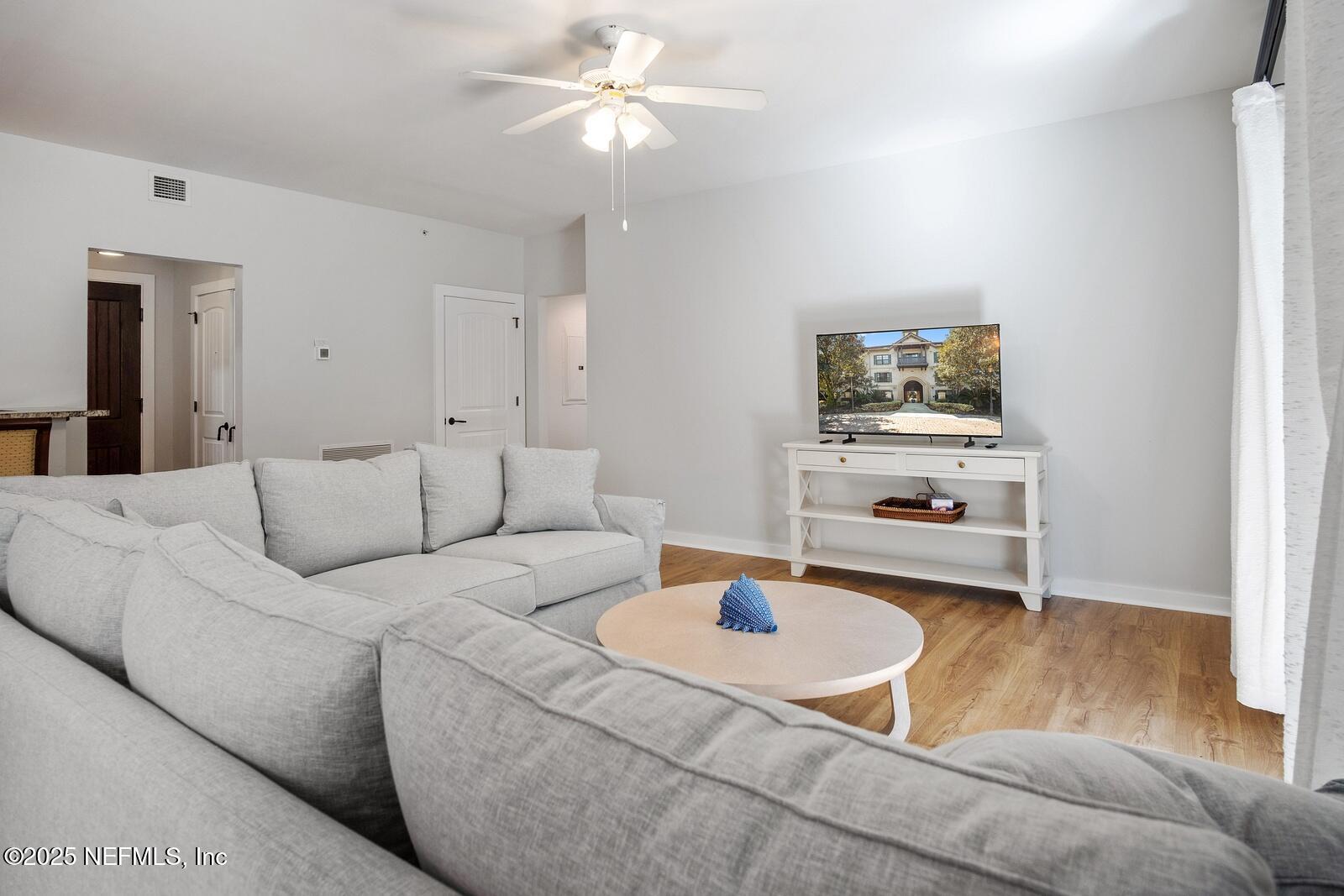 945 Registry Boulevard, Unit 210 St. Augustine, FL 32092 - Photo 6 of 28 a living room with furniture and a flat screen tv