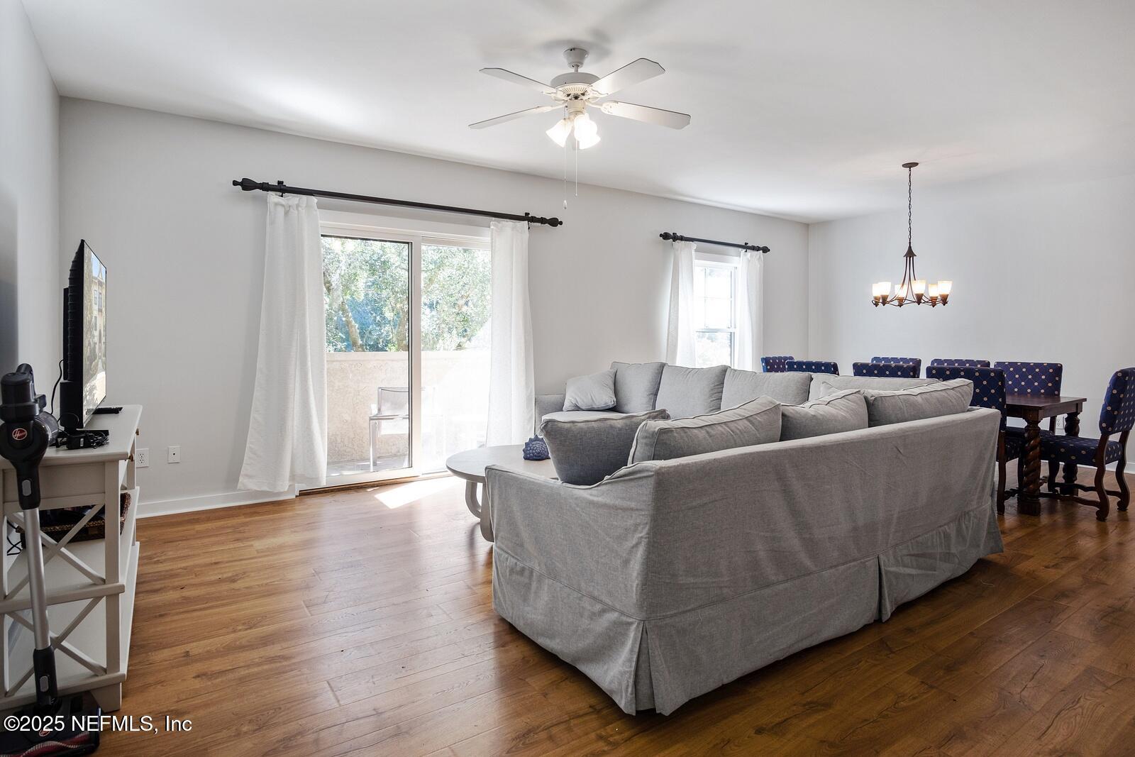 945 Registry Boulevard, Unit 210 St. Augustine, FL 32092 - Photo 7 of 28 a living room with furniture and wooden floor