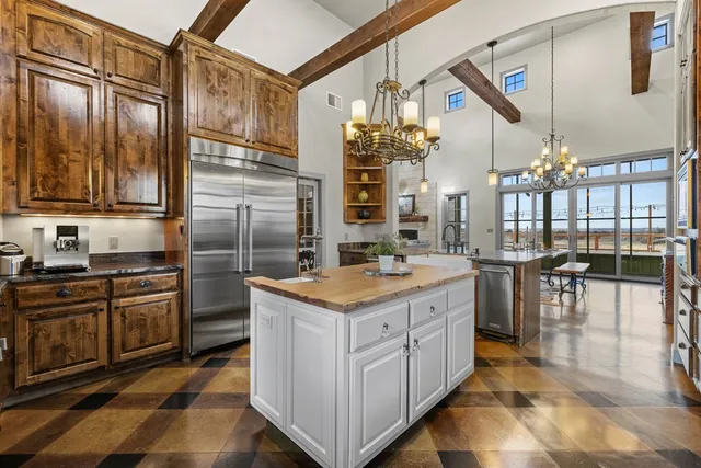 a kitchen with stainless steel appliances granite countertop a stove and cabinets