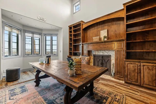 a living room with furniture a fireplace and a table