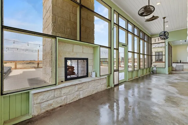 a view of a porch with a table and chairs