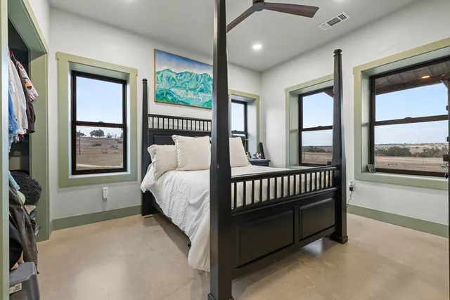 a bed sitting in a bedroom next to a window