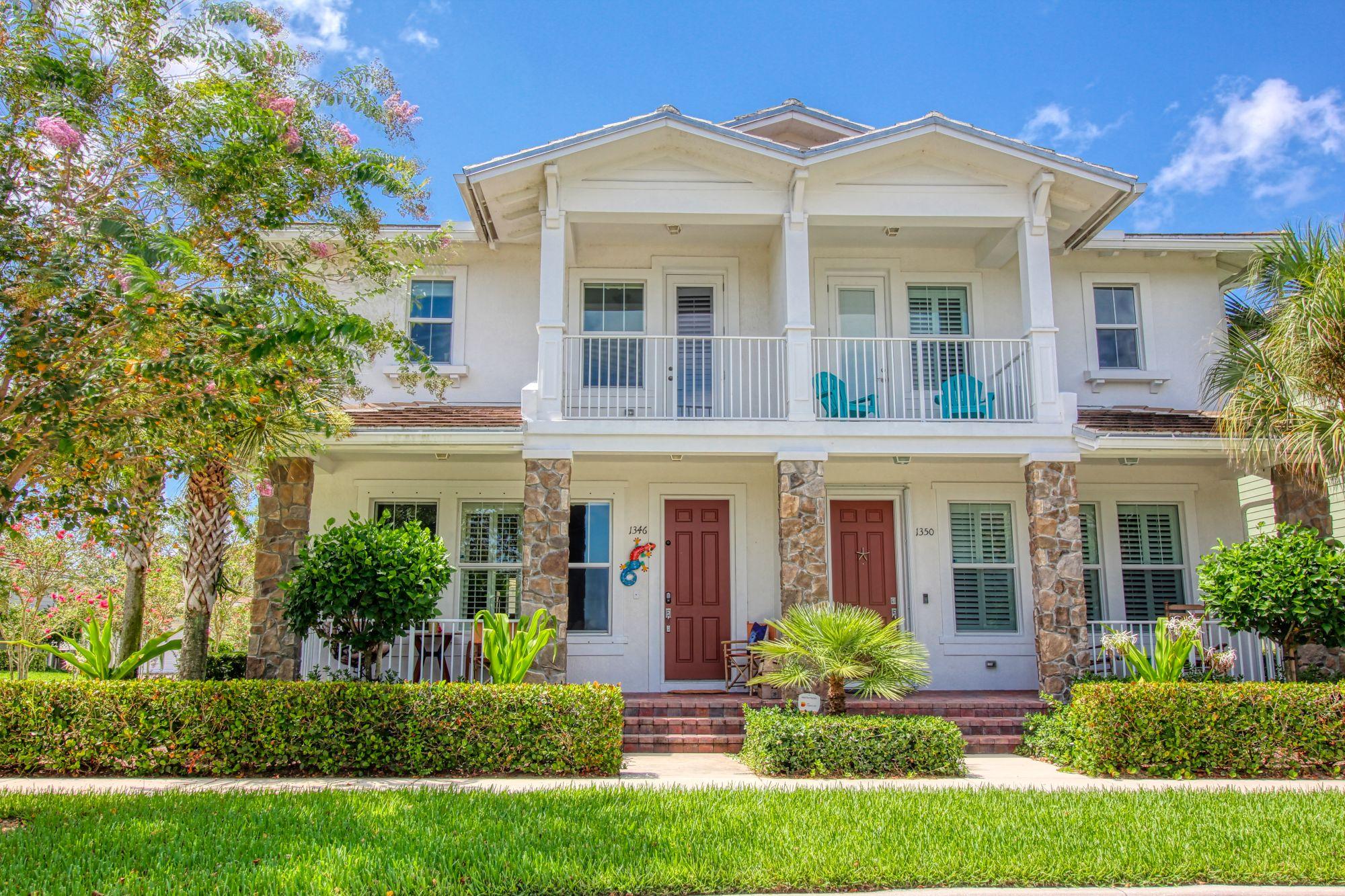 front view of a brick house with a yard