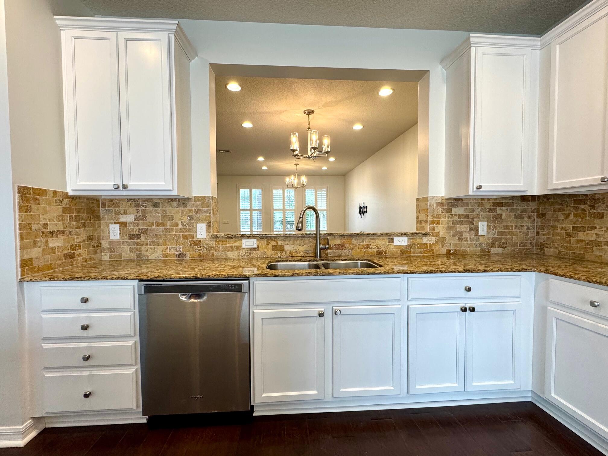 1346 Turnbridge Drive Jupiter, FL 33458 - Photo 11 of 46 a kitchen with white cabinets and sink