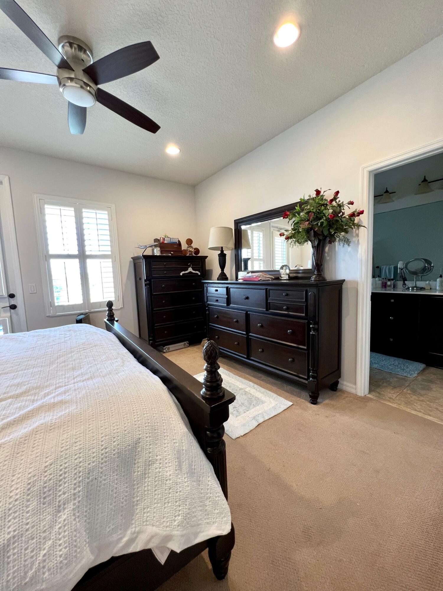 1346 Turnbridge Drive Jupiter, FL 33458 - Photo 19 of 46 a bedroom with a bed dresser and a window