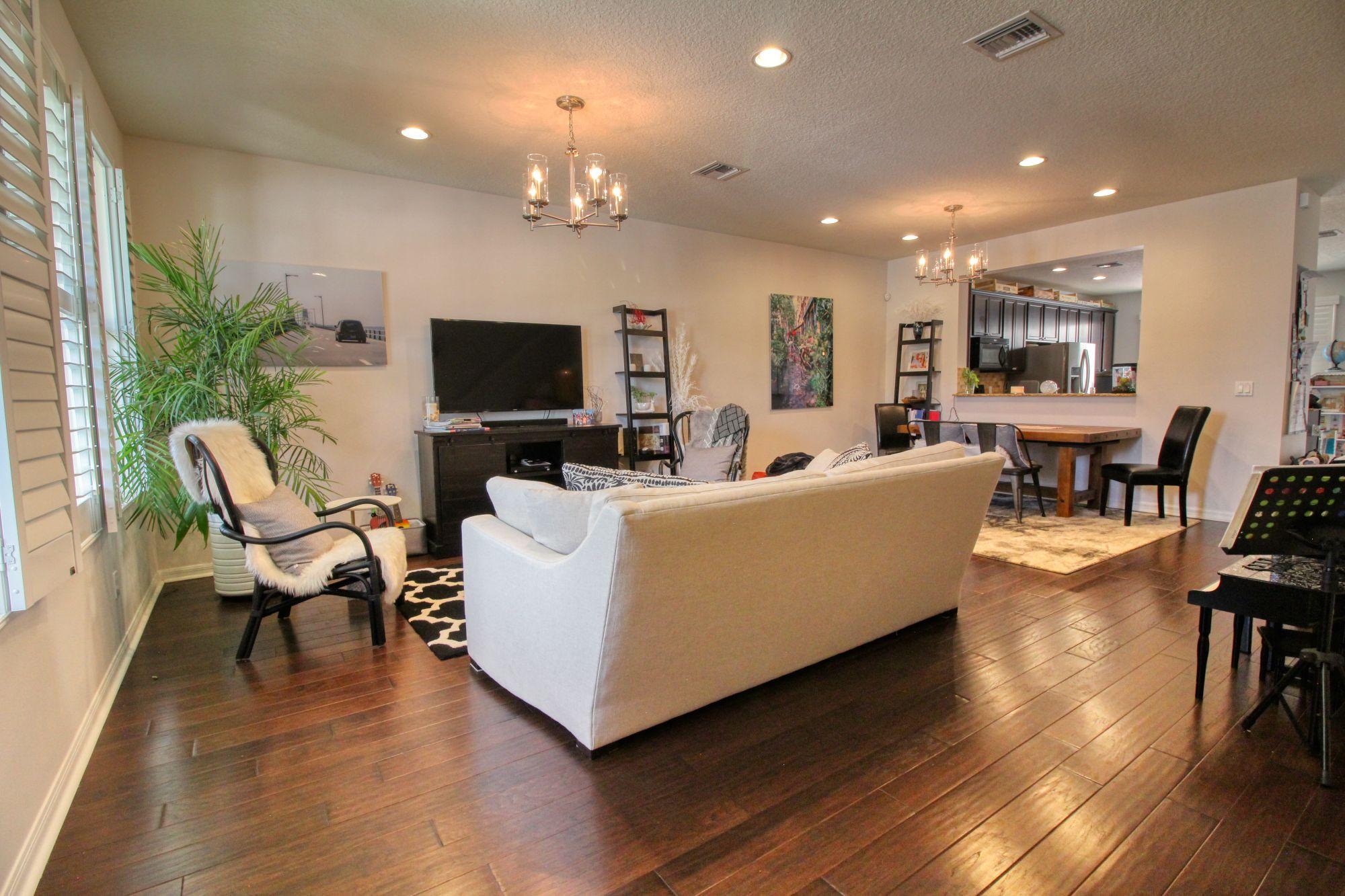 1346 Turnbridge Drive Jupiter, FL 33458 - Photo 6 of 46 a living room with furniture and a flat screen tv