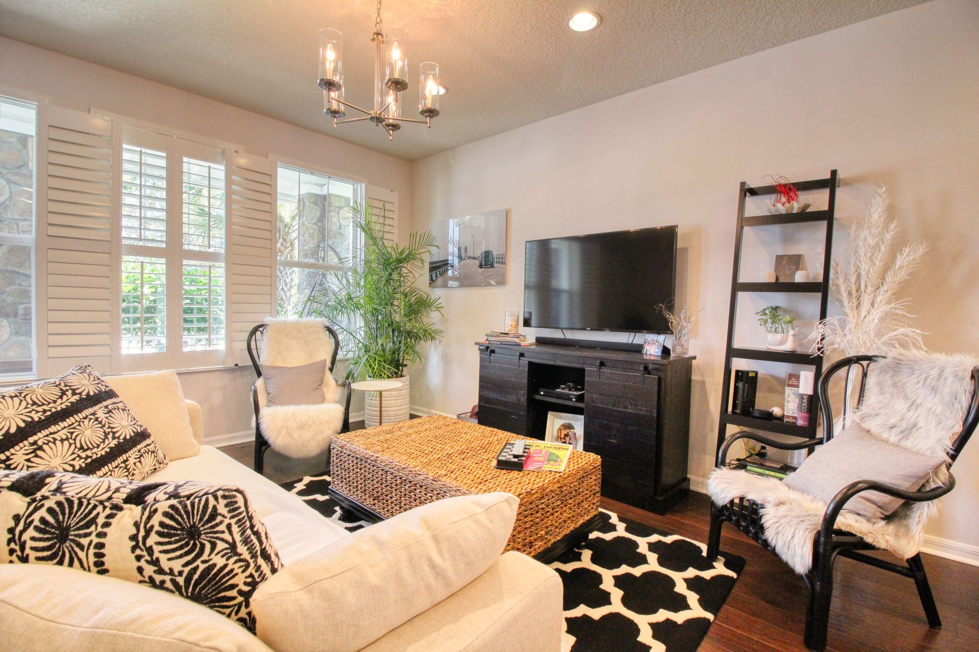 1346 Turnbridge Drive Jupiter, FL 33458 - Photo 8 of 46 a living room with furniture a flat screen tv and large windows