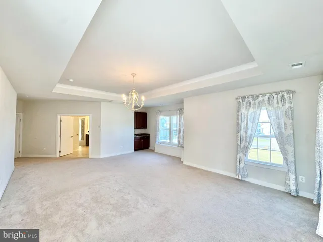 a view of an empty room with a fireplace