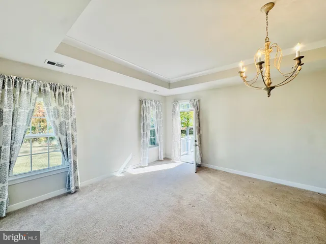 a large white kitchen with a sink a stove a refrigerator and a cabinets