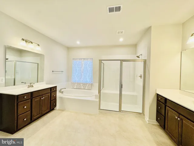 a view of a hallway with wooden floor and windows