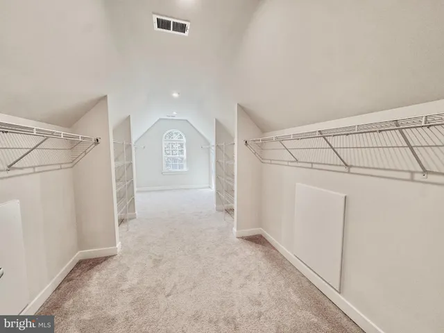 a view of a hallway with wooden floor and stairs