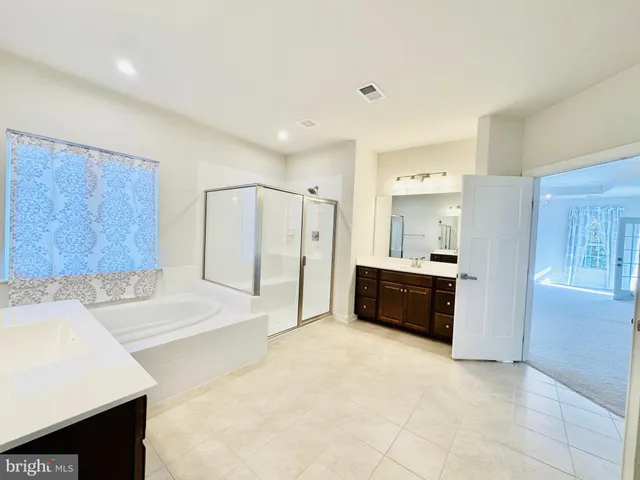 a bathroom with a sink a toilet a shower and a mirror