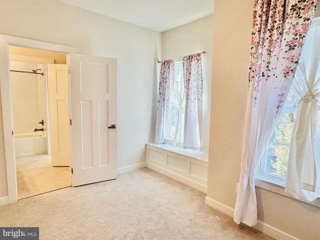 a spacious bathroom with a toilet a sink and a mirror