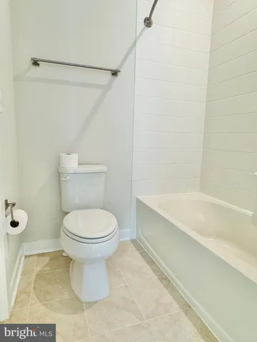 a view of a livingroom with wooden floor and stairs