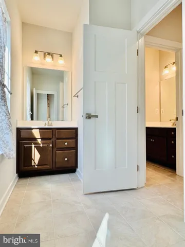 a view of a room with wooden floor staircase and a chandelier