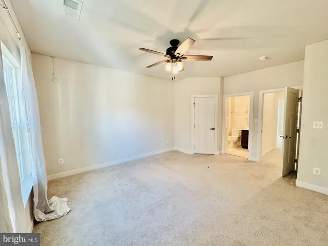 a large kitchen with cabinets and a wooden floor