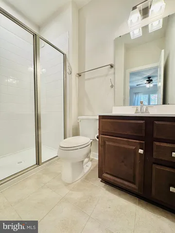 a large kitchen with stainless steel appliances wooden cabinets and a wooden floor