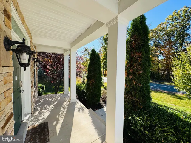 a view of an empty room with fire place and a window