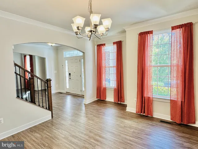 a large kitchen with stainless steel appliances kitchen island granite countertop a large counter top a stove a sink a refrigerator and a cabinets