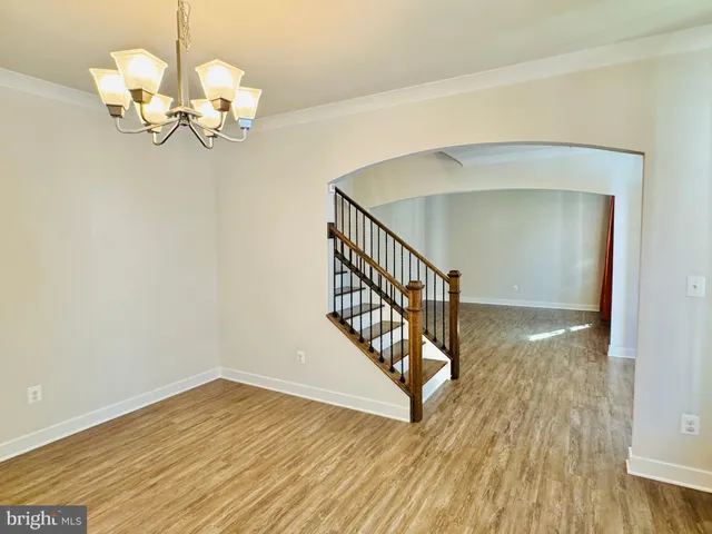 a large kitchen with stainless steel appliances granite countertop a large counter top and a wooden floors