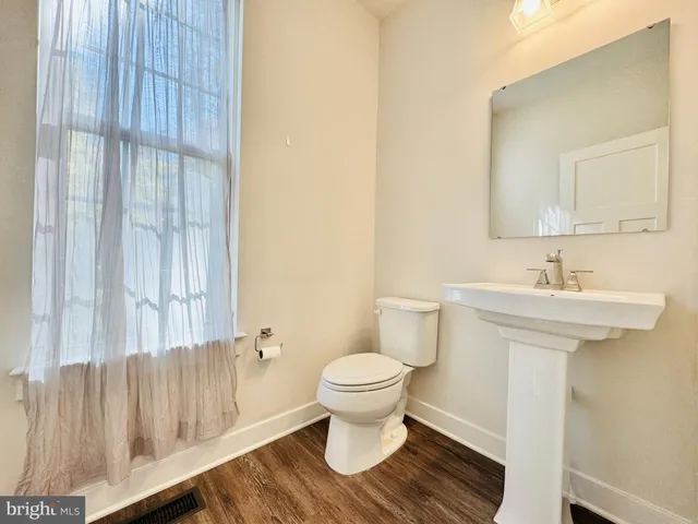 a kitchen with stainless steel appliances a refrigerator and wooden floor
