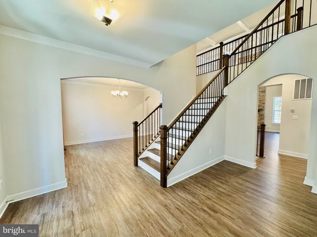 an empty room with windows and cabinet