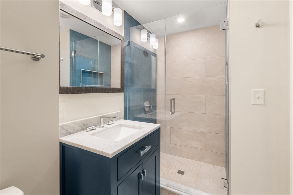 11 East Evergreen Road Natick, MA 01760 - Photo 16 of 30 a bathroom with a shower sink and mirror