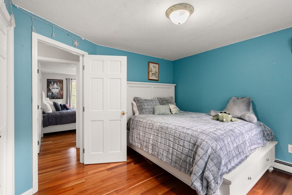 11 East Evergreen Road Natick, MA 01760 - Photo 17 of 30 a bedroom with a bed and wooden floor