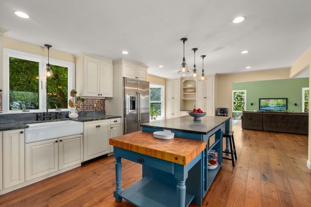 11 East Evergreen Road Natick, MA 01760 - Photo 4 of 30 a kitchen with kitchen island granite countertop lots of counter top space and stainless steel appliances