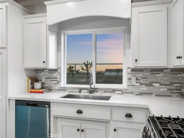 a kitchen with stainless steel appliances a sink and cabinets