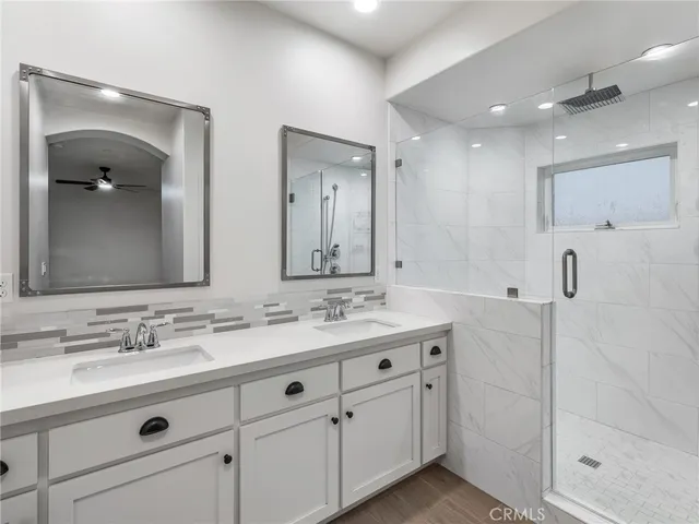 a bathroom with double sink and a mirror