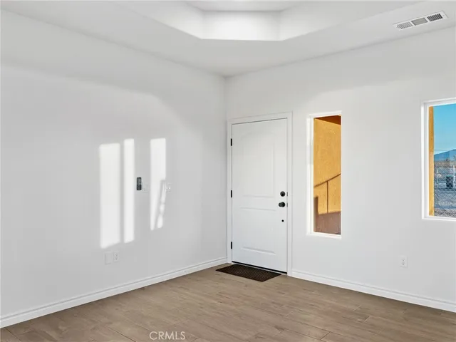 an empty room with windows and closet