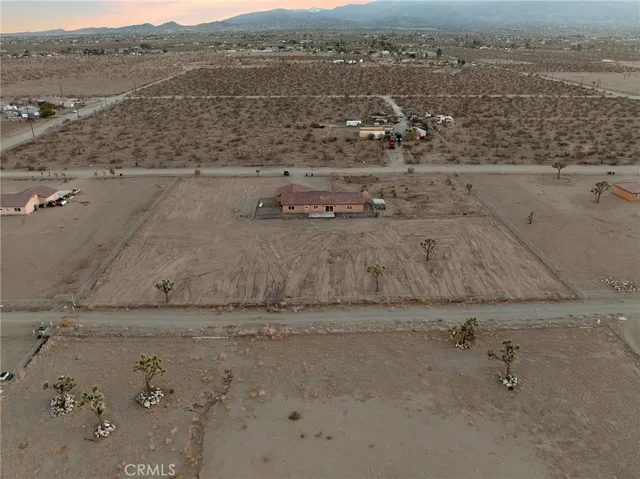 a view of a mountain with a field