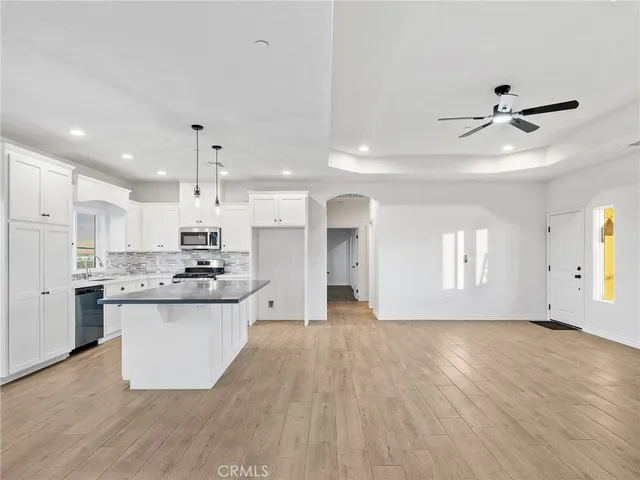 a large kitchen with cabinets and wooden floor