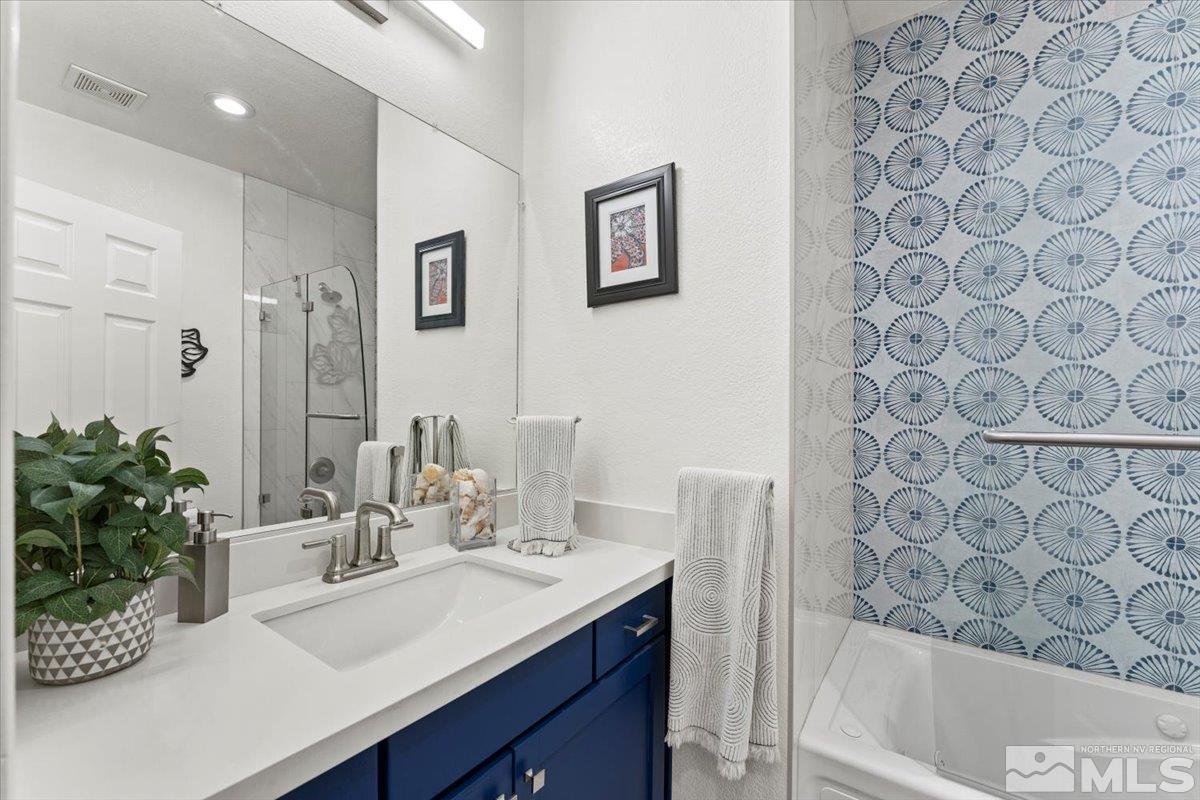 2151 Brittany Meadows Drive Reno, NV 89521 - Photo 15 of 40 a bathroom with a sink a vanity and a mirror