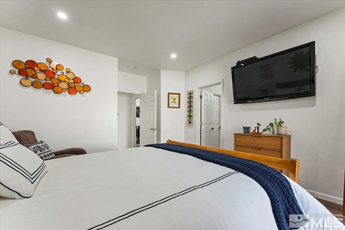 2151 Brittany Meadows Drive Reno, NV 89521 - Photo 17 of 40 a bedroom with a bed and a flat screen tv