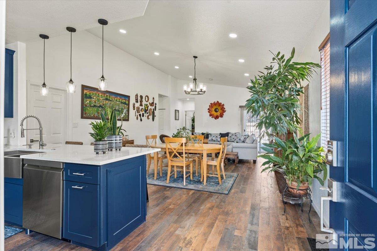 2151 Brittany Meadows Drive Reno, NV 89521 - Photo 3 of 40 a kitchen with kitchen island granite countertop a sink a counter top space and living room
