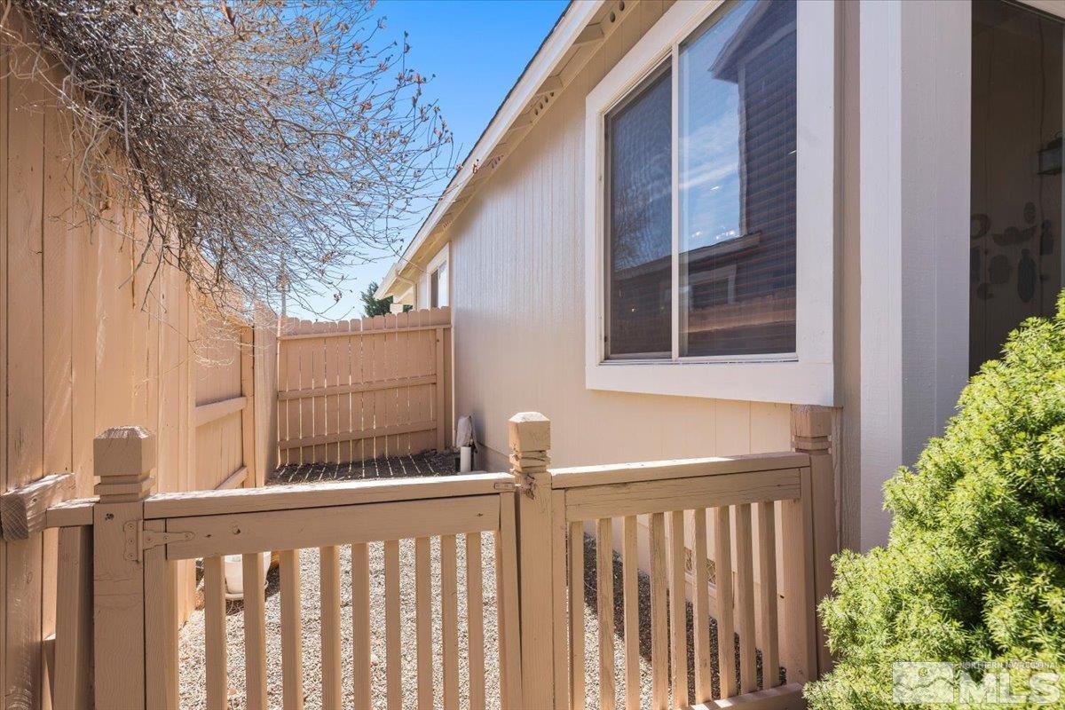 2151 Brittany Meadows Drive Reno, NV 89521 - Photo 31 of 40 a view of a brick house with wooden fence