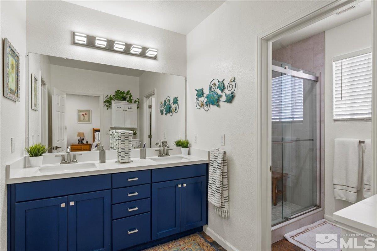2151 Brittany Meadows Drive Reno, NV 89521 - Photo 5 of 40 a bathroom with a double vanity sink and a mirror