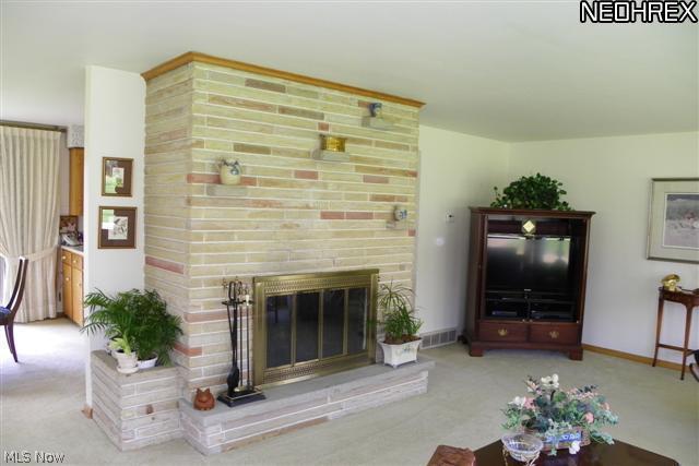 2434 Woodview Road Uniontown, OH 44685 - Photo 12 of 23 Great room w/ wood burning fireplace & wonderful wall of windows